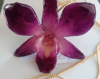 Natural Dendrobium orchid incorporated in resin with galvanized gold slider adjustable as desired