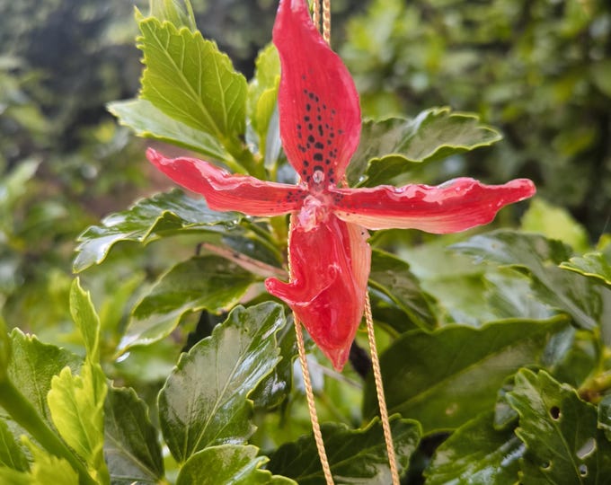 Red orchid necklace embedded in resin and adjustable gold clasp