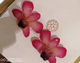 Pair of natural orchid earrings incorporated in resin with silver hooks