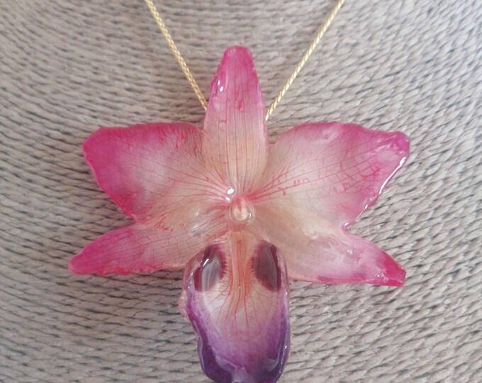 Hybrid orchid necklace embedded in resin and finished with gold on bronze sliders