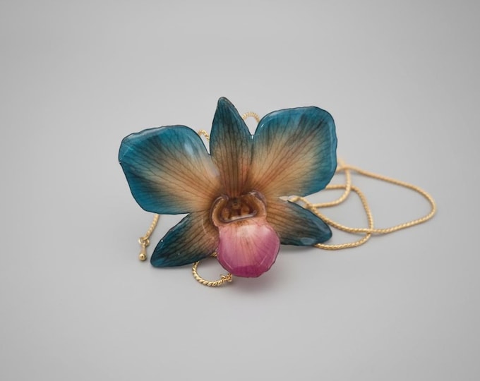 Rare blue orange resin orchid necklace with adjustable gold clasp.