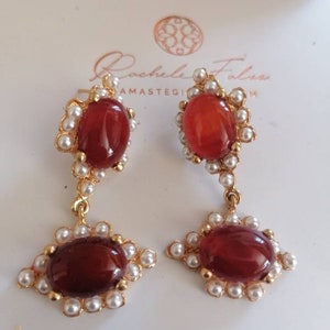Pair of matt gold on bronze pendant earrings, worked with natural carnelian and pearls