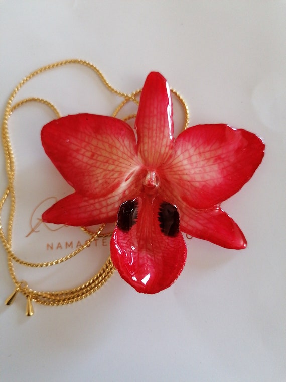 Latch with red hybrid orchid incorporated in resin