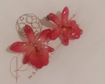 Mini light red Cattlaya orchids embedded in resin with silver hook on the lobe