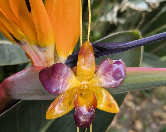 Yellow-purple orchid necklace embedded in resin and gold latch