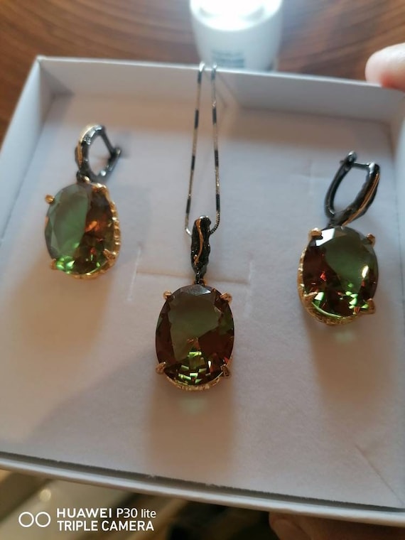 Burnished silver earrings and pendant set with gold embroidery. Multicolor iridescent Diaspore