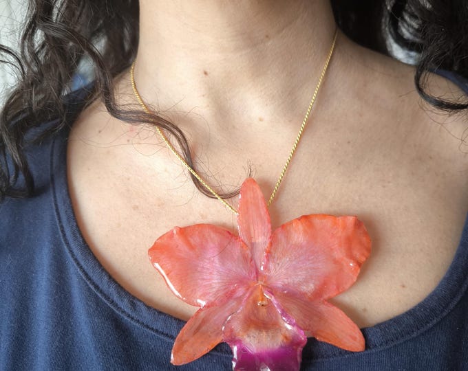 Large orange Cattleya orchid encased in resin with gold slider