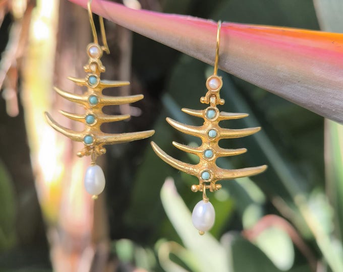 Gold-on-bronze fish earrings finished with natural pearls and turquoise.