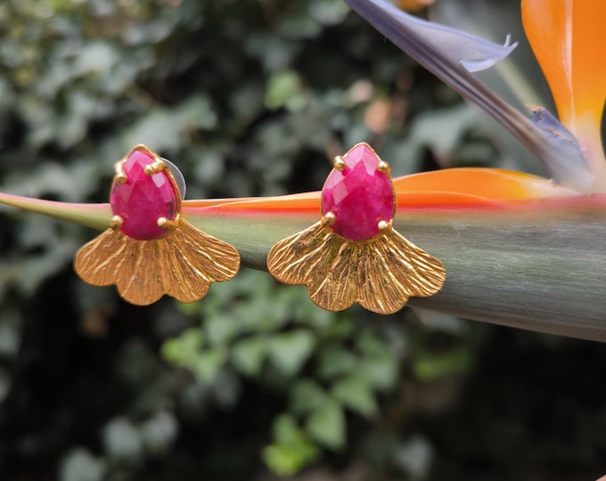 Small gold-on-bronze stud earrings finished with natural faceted red agates. Handmade jewelry.