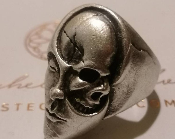 Adjustable rhodium-plated silver and aluminum ring depicting two skull faces and human face