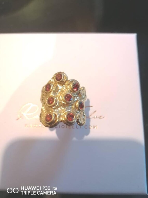 Adjustable ring in gold on bronze and finished with Amethysts or orange spinels