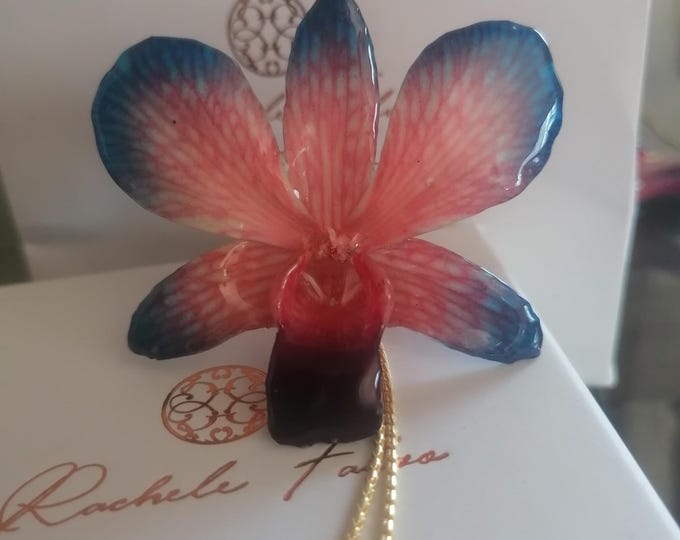 spectacular blue/red orchid embedded in resin and finished with gold on bronze adjustable slider