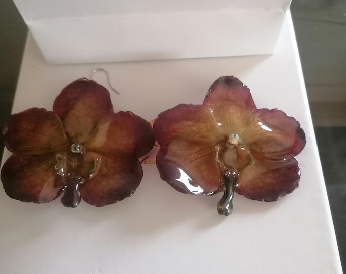 Earrings with purple orchids and yellow highlights, embedded in resin