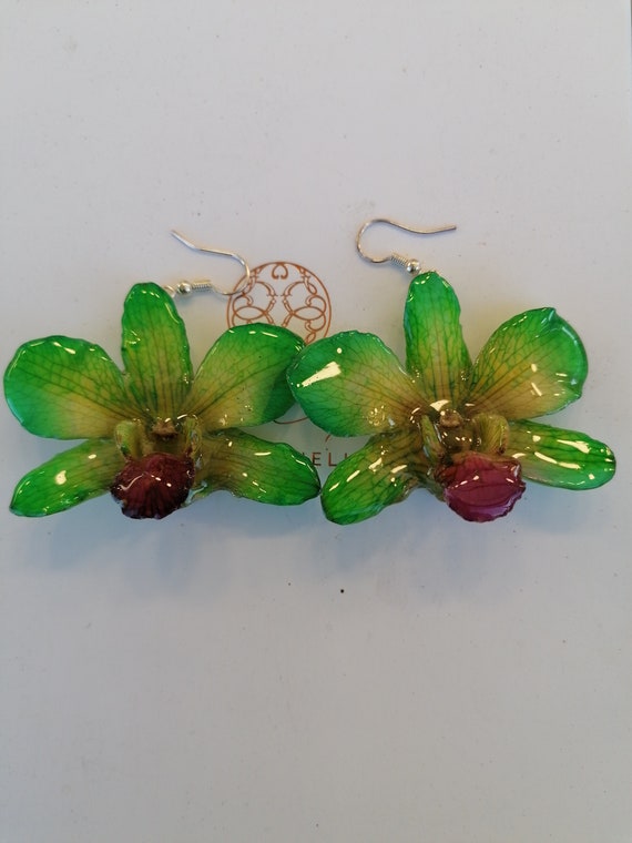 Pair of natural pearly green orchids embedded in resin, silver hook