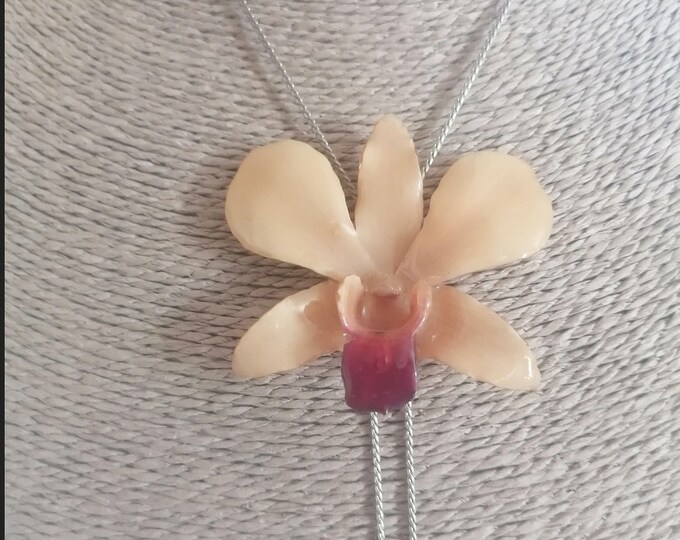 Cream orchid necklace embedded in resin and finished with silver latch