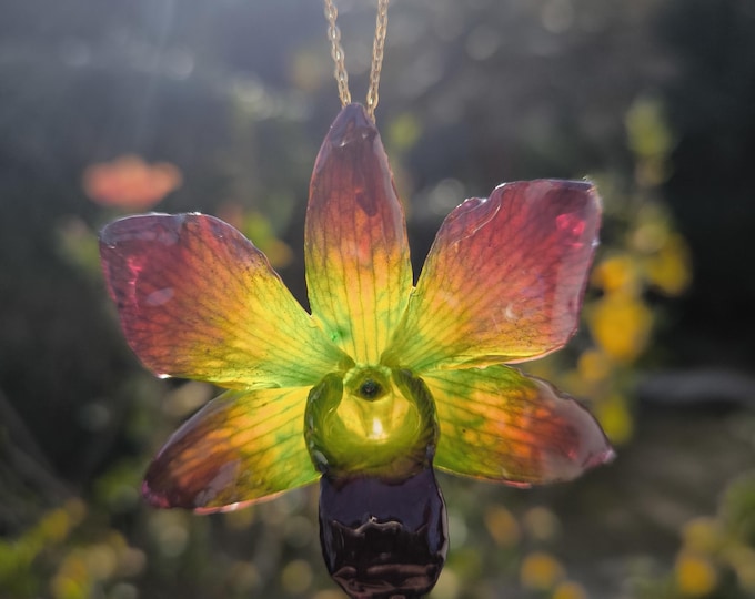 Emerald green orchid necklace embedded in resin complete with gold-plated silver chain.