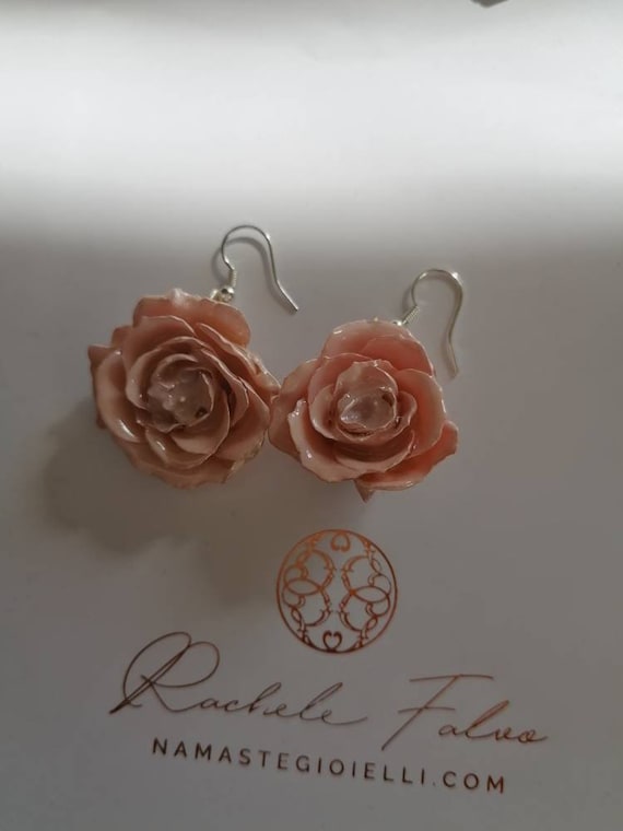 Earrings of natural roses incorporated in resin