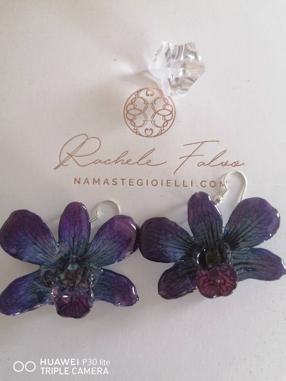 Natural orchid earrings incorporated in resin with silver hook.
