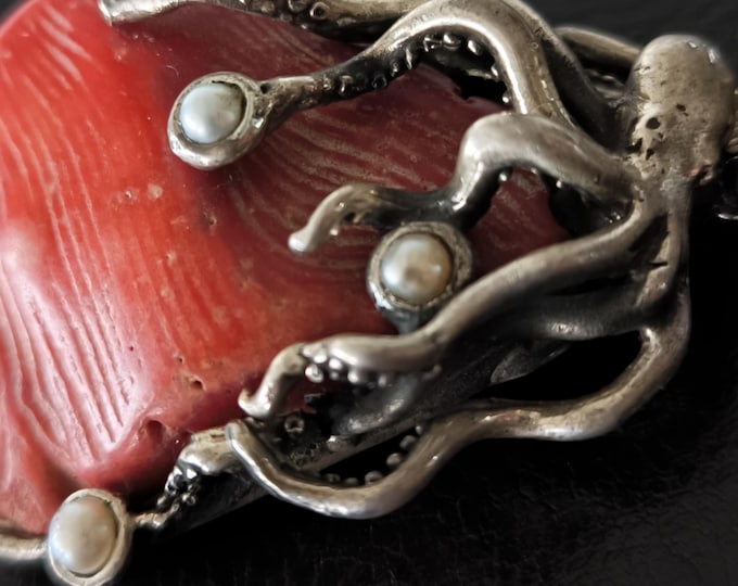 silver pendant and sea creatures