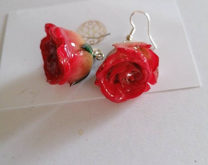 Pair of natural roses embedded in resin with a silver hook