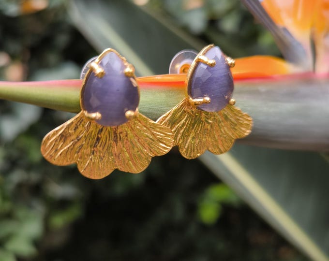 Gold-on-bronze stud earrings finished with natural faceted purple cat's eyes.