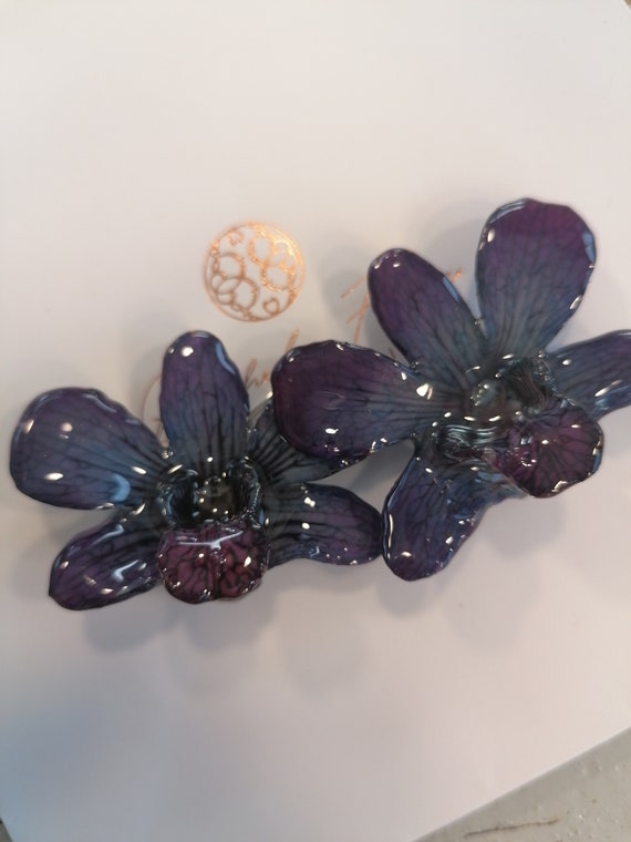 Rare pair of natural black purple orchids embedded in resin