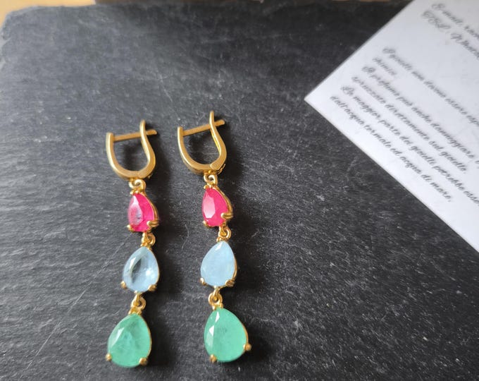 925% silver and gold-plated earrings crafted and finished with high-quality natural rubies, emeralds, and aquamarines.