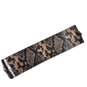 May include: A brown and black snakeskin patterned leather bracelet with gold-toned hardware.