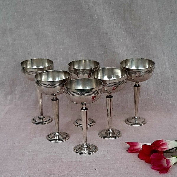 Small antique silver shooter glasses.