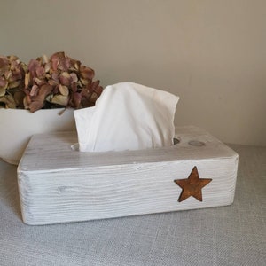 May include: White wooden tissue box holder with a rustic finish and a small, rusty star on the front.