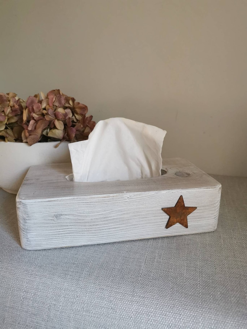 May include: White wooden tissue box holder with a rustic finish and a small, rusty star on the front.