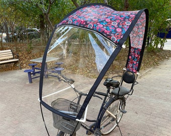 Bicycle rain hood with multi-colored floral patterns and flexible crystal PVC windshield