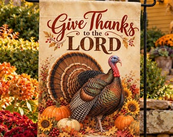 May include: A rectangular garden flag featuring a turkey standing among pumpkins, sunflowers, and autumn leaves. The text "Give Thanks to the LORD" is printed in brown script and serif font at the top, with "Psalm 136:1" at the bottom.