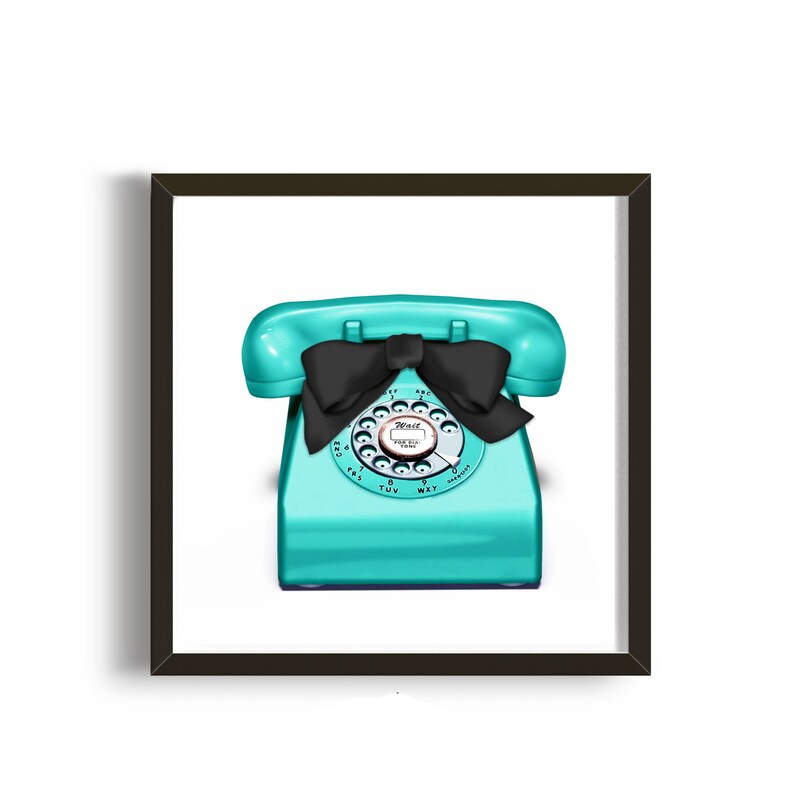 May include: A turquoise rotary phone with a black bow on the receiver. The phone has a white dial with black numbers and letters.