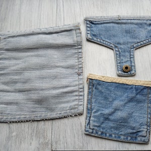 May include: Three denim patches, two are square and one is a rectangle with a rounded top. The rectangle has a button on the back.
