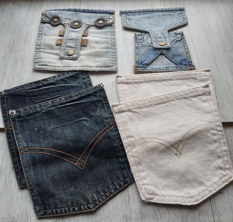 May include: Four different fabric swatches, two are denim and two are a light beige fabric. The denim swatches are a dark blue and a lighter blue. The beige swatches are a light beige and a slightly darker beige.