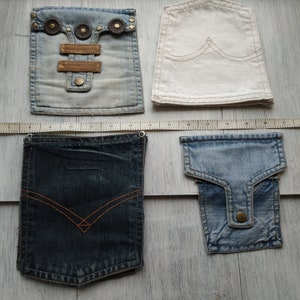 May include: Four different denim pockets, two are light blue, one is dark blue, and one is white. The pockets are all different sizes and shapes.