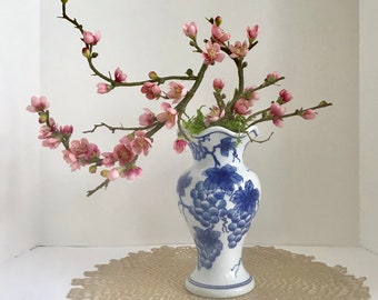 Jardinière de bonsaï avec les fleurs rouges artificielles de cerise dans un vase asiatique bleu et blanc de raisin de porcelaine asiatique