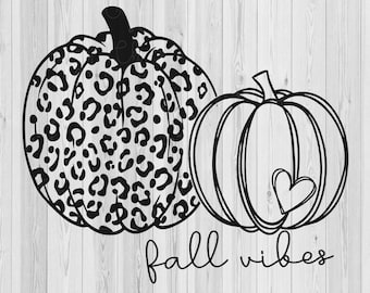 May include: Black and white illustration of two pumpkins. One pumpkin is a leopard print design. The other pumpkin has a heart on it. The text "fall vibes" is below the pumpkins.