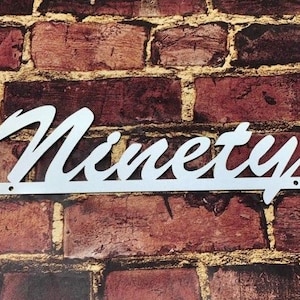 May include: White metal sign with the word "Ninety" written in a cursive font.
