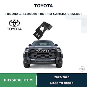 May include: A black camera bracket for Toyota Tundra and Sequoia TRD Pro models, displayed above a front view of a dark gray Toyota Tundra truck. The text reads TOYOTA, TUNDRA & SEQUOIA TRD PRO CAMERA BRACKET, PHYSICAL ITEM, and 2022-2026.