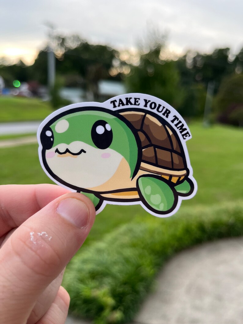 May include: A green and brown cartoon turtle sticker with big eyes and the text "TAKE YOUR TIME" on the shell.