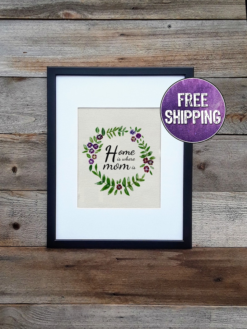 Home is where mom is with a circle of flowers around it featured on a cream colored canvas sheet