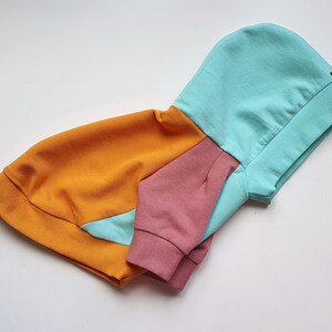 Color-block dog hoodie in mint, mustard yellow, and dusty pink. Handmade from soft cotton French Terry for teacup, small dogs, and puppies. Cozy, stylish, and lightweight pet sweater with custom fit. Perfect for chilly walks and everyday wear. Custom-made to fit different dog breeds like Yorkies, Chihuahuas, and Toy Poodles. High-quality craftsmanship with durable stitching.