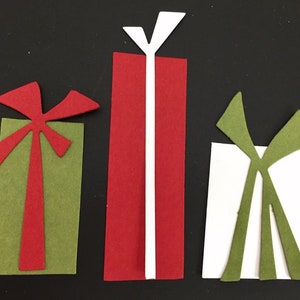 May include: Three colorful gift boxes with bows. The gifts are in shades of green, red, and white, with contrasting bows. The image is set against a black background, creating a festive and eye-catching display.