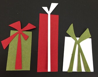 May include: Three colorful gift boxes with bows. The gifts are in shades of green, red, and white, with contrasting bows. The image is set against a black background, creating a festive and eye-catching display.