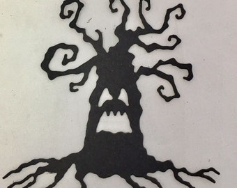 May include: Black Halloween tree cutout with a spooky face and gnarled branches. The tree has a wide open mouth and a pair of eyes. The tree's roots spread out at the bottom. The tree is on a white background.