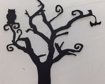 May include: Black silhouette of a tree with an owl perched on a branch. The tree has a whimsical design with curly branches and a thick trunk. The owl is facing left, and the background is white.