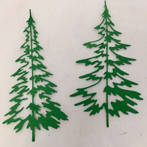 May include: Two green paper cutouts of evergreen trees. The trees have detailed, jagged edges, and are displayed against a white background. The cutouts are similar in shape, with a pointed top and a trunk.