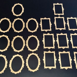 May include: A collection of decorative wooden frames in various shapes, including oval and rectangular designs. The frames are light brown and feature ornate, detailed edges. The arrangement includes multiple sizes and styles, suitable for crafts or home decor projects.